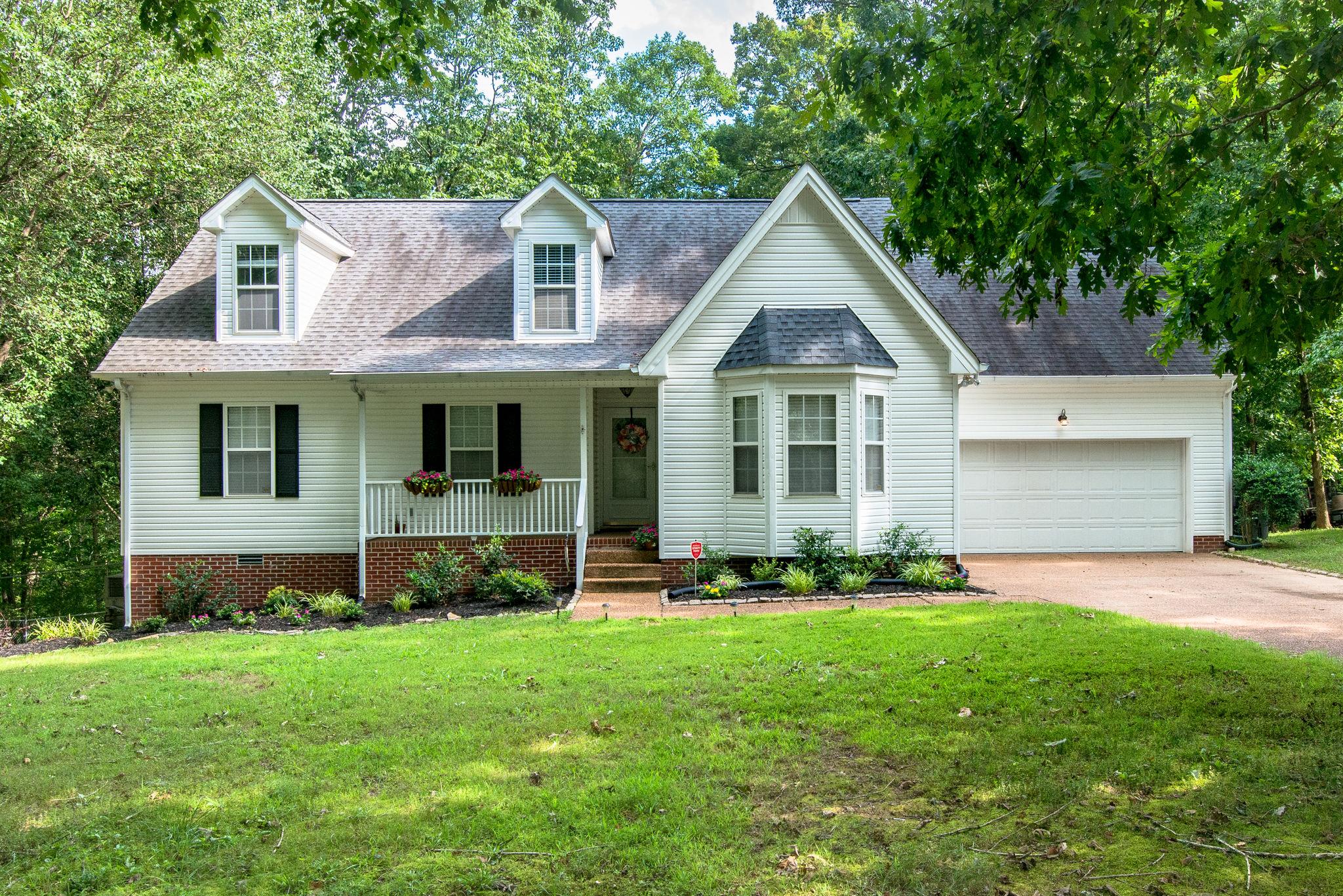 1020 Anderson Road Dickson, TN 37055 - Photo 1 of 28 a front view of a house with a garden and yard
