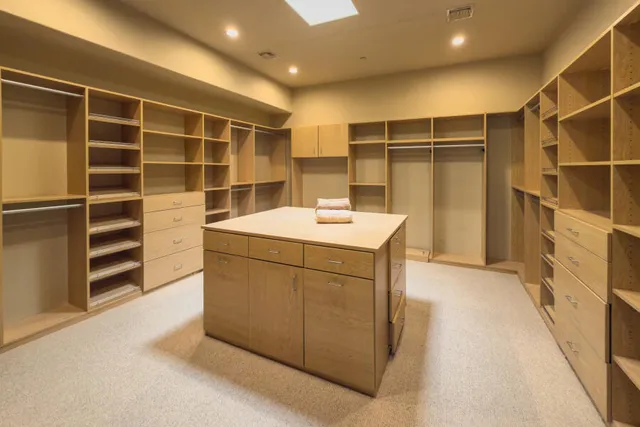 a spacious bedroom with a bed and a couch