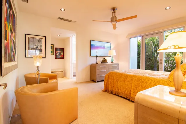 a bedroom with a bed and a large window