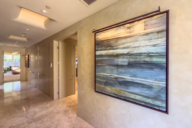 a living room with furniture a fireplace and a potted plant