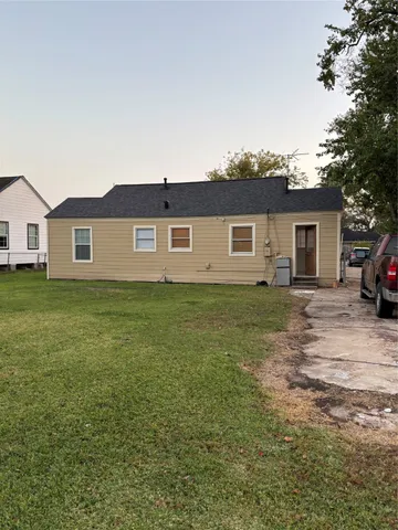 a front view of house with yard and trees around