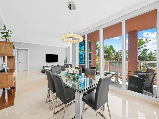 a dining room with furniture and a flat screen tv