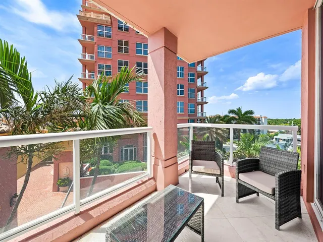 a view of a chairs and table in the balcony