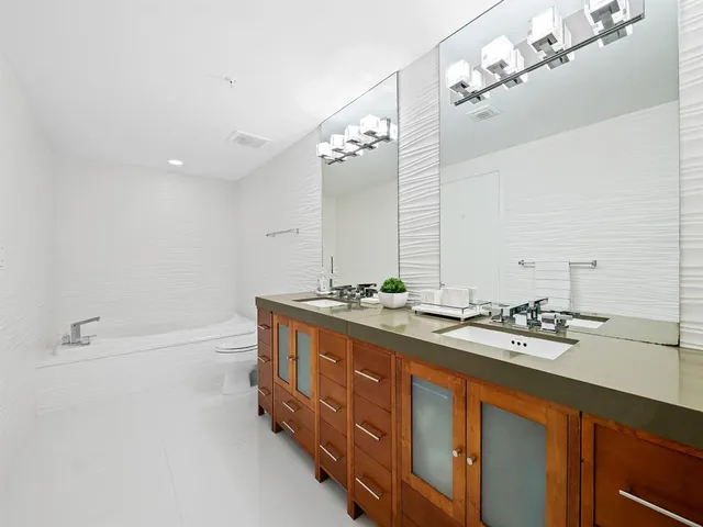 a bathroom with a double vanity sink and a mirror