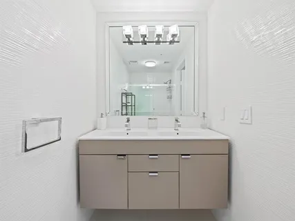 a bathroom with a double vanity sink and a mirror