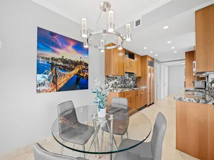 a view of a dining room with furniture a chandelier and wooden floor