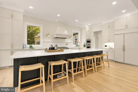a bathroom with a sink vanity mirror and toilet