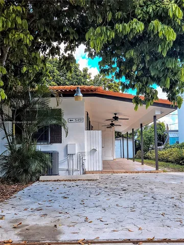 a view of a backyard with a tree