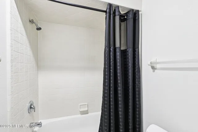 a bathroom with a shower and a tub