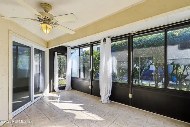 a view of a hallway with a glass door and an entryway