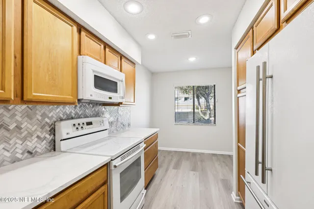 a kitchen with stainless steel appliances a stove a sink and a microwave