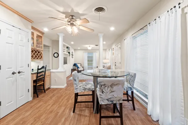 a living room with furniture and a view of kitchen