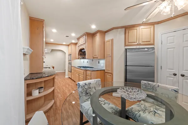 a kitchen with a stove a sink and a refrigerator