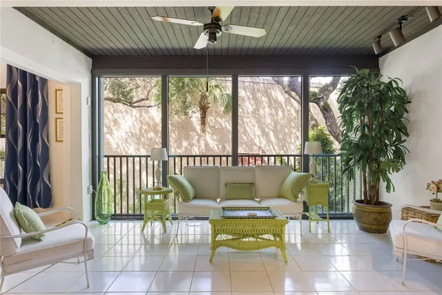 a living room with furniture and a large window with outer view