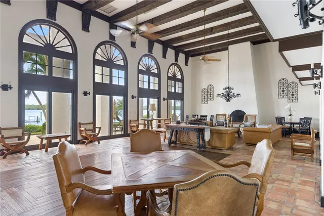 a view of a dining room with furniture a chandelier and wooden floor