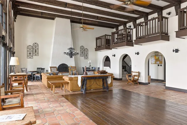 a living room with fireplace furniture and a wooden floor