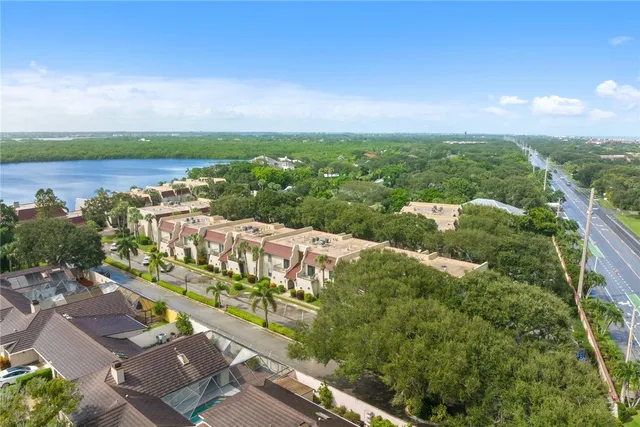 an aerial view of a city with lots of residential buildings and ocean view