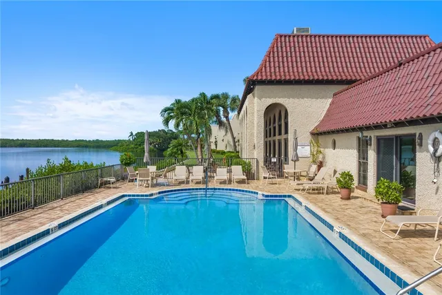 a view of a house with a swimming pool and sitting area