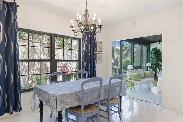a view of a dining room with furniture a chandelier and wooden floor