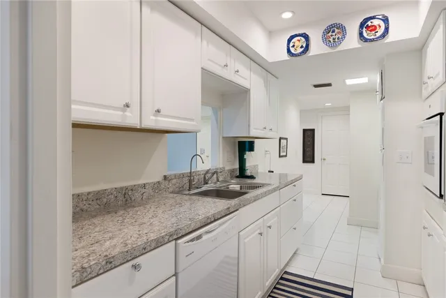 a kitchen with stainless steel appliances granite countertop a sink and cabinets