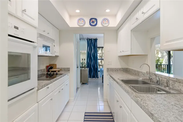 a kitchen with granite countertop a sink and cabinets