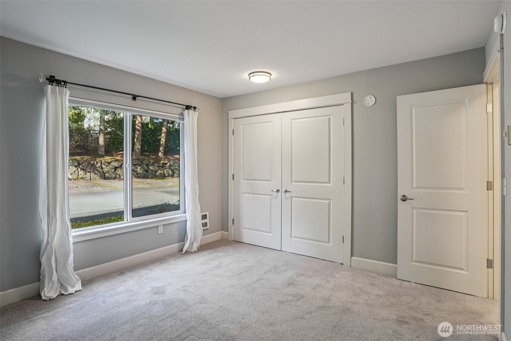 8025 234th Street Southwest, Unit 116 Edmonds, WA 98026 - Photo 11 of 26 an empty room with sliding door