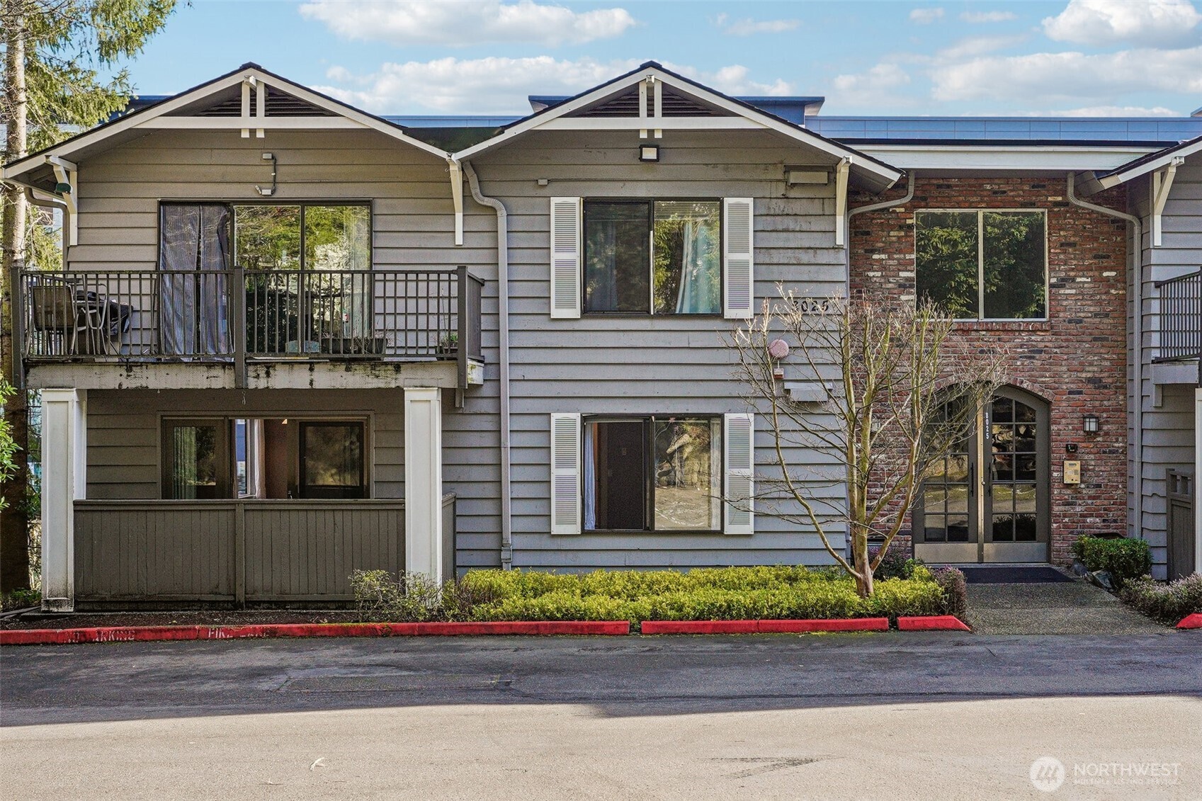 8025 234th Street Southwest, Unit 116 Edmonds, WA 98026 - Photo 17 of 26 a front view of a house with a yard