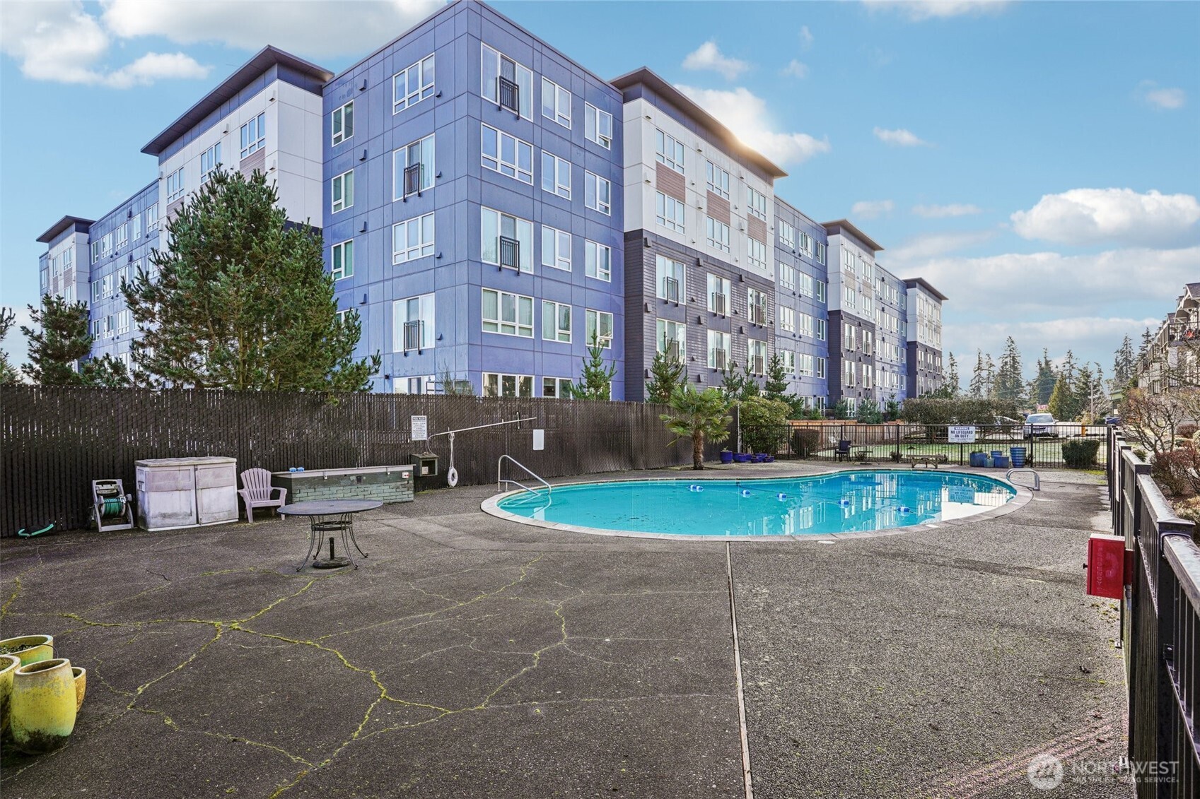 8025 234th Street Southwest, Unit 116 Edmonds, WA 98026 - Photo 23 of 26 a view of a swimming pool with a patio and a fire pit