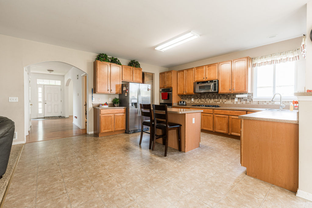 508 Winding Trail Genoa, IL 60135 - Photo 13 of 41 a kitchen with a sink a counter top space a refrigerator and cabinets