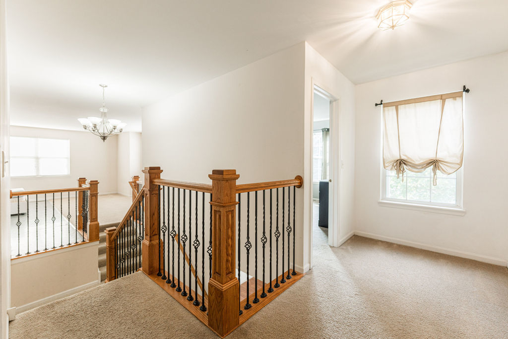 508 Winding Trail Genoa, IL 60135 - Photo 23 of 41 an empty room with windows & stairs