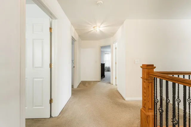 a view of a hallway with a livingroom and entryway