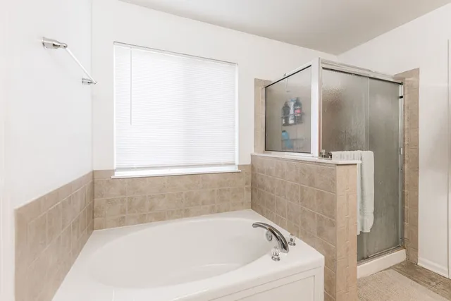 a bathroom with a bathtub and a shower
