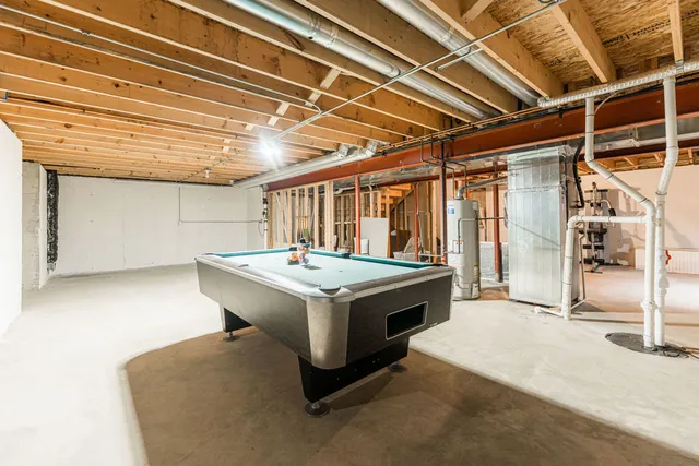 a utility room with a stove and furniture