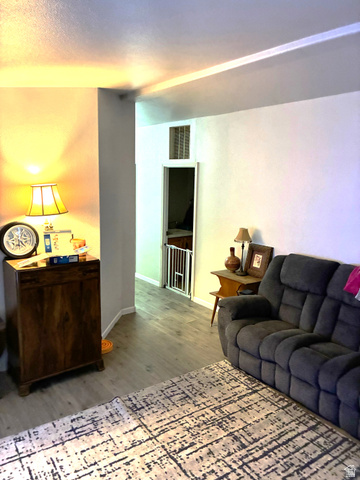 547 East 2000th Street North Vernal, UT 84078 - Photo 22 of 50 Living space featuring wood-finish flooring, light-toned walls, and an overhead ventilation register