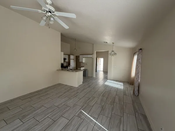 a view of a kitchen with wooden floor and electronic appliances
