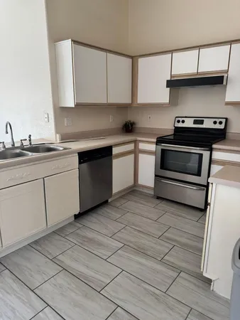 a kitchen with appliances cabinets and a sink