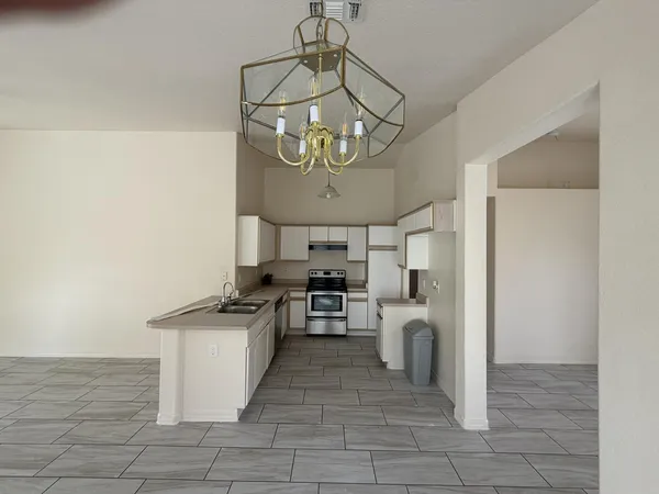 a kitchen with stainless steel appliances granite countertop a sink a stove oven and cabinets