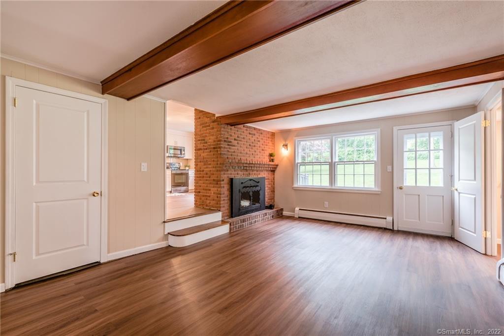 31 Old Reservoir Road Wethersfield, CT 06109 - Photo 1 of 1 Spacious Sunken Family Room with wood beams, fireplace and door leading out to the patio.