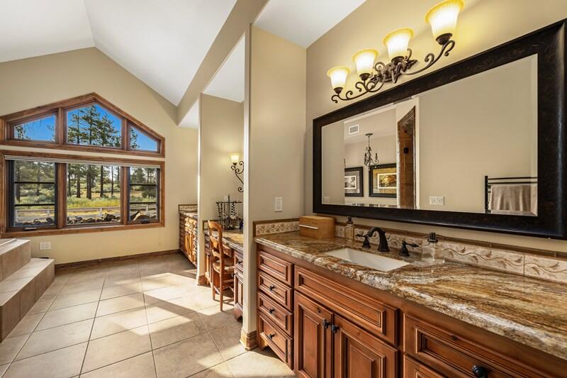 35650 Pyramid Peak Road Mountain Center, CA 92561 - Photo 27 of 58 a bathroom with a sink a large mirror and a bathtub