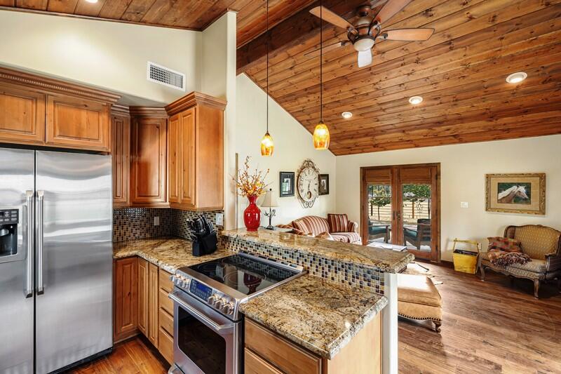35650 Pyramid Peak Road Mountain Center, CA 92561 - Photo 41 of 58 a kitchen with stainless steel appliances granite countertop a stove a refrigerator a sink and dishwasher