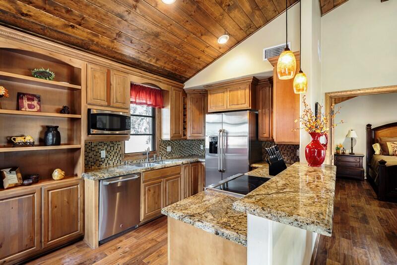 35650 Pyramid Peak Road Mountain Center, CA 92561 - Photo 43 of 58 a kitchen with stainless steel appliances granite countertop a sink dishwasher stove and cabinets