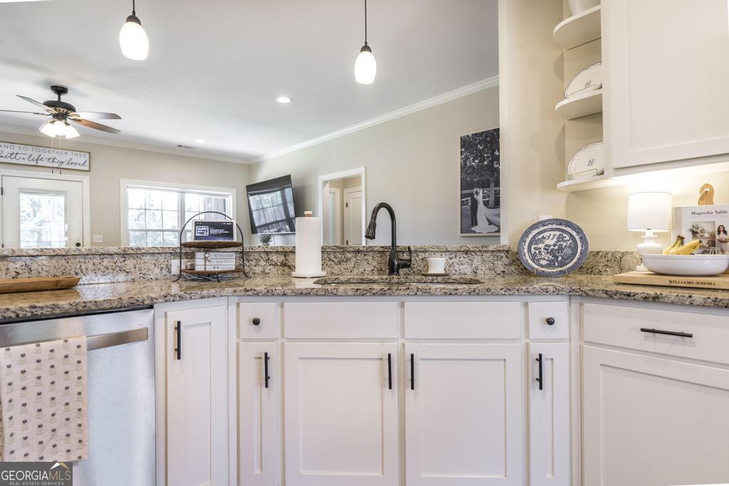 609 Live Oak Way Dublin, GA 31021 - Photo 14 of 37 a kitchen with granite countertop a sink a stove and cabinets