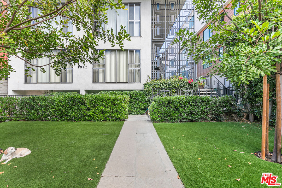 1812 North Gramercy Place, Unit 11 Los Angeles, CA 90028 - Photo 17 of 18 a front view of a house with garden