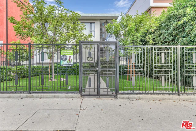 a view of a house with a large windows and a yard