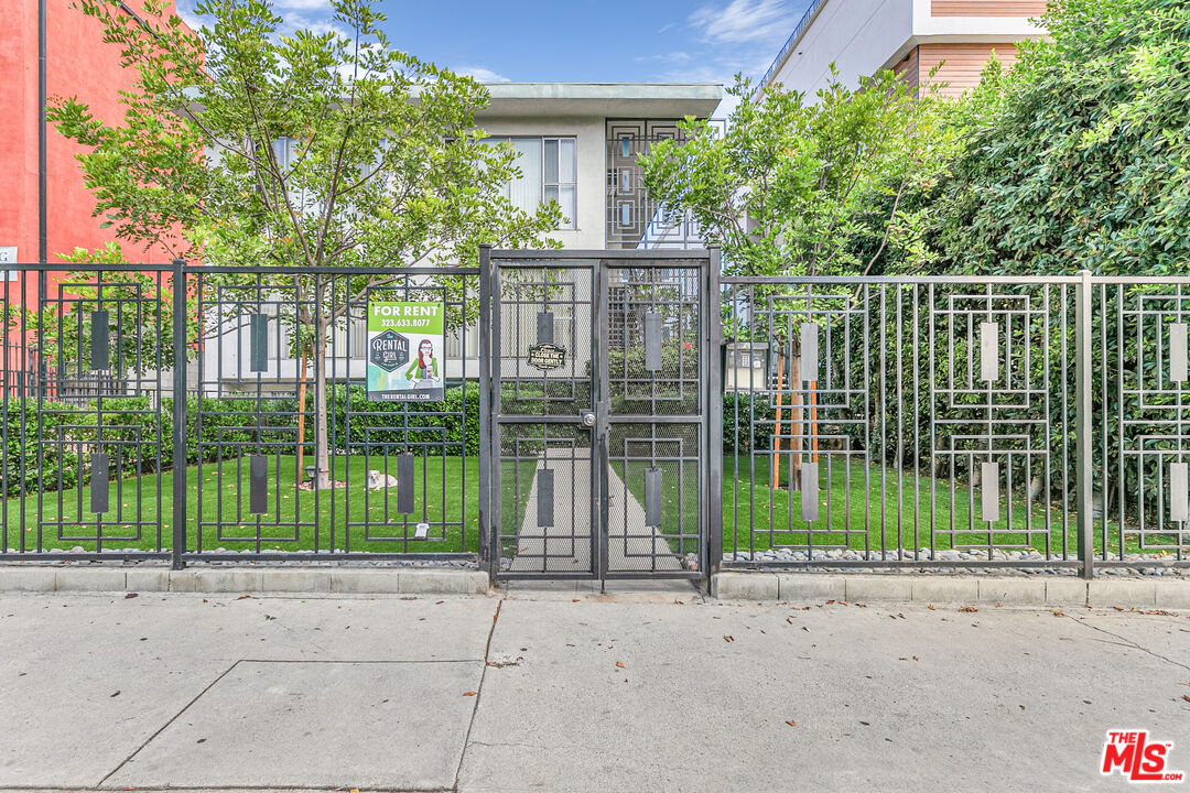 1812 North Gramercy Place, Unit 11 Los Angeles, CA 90028 - Photo 18 of 18 a view of a house with a large windows and a yard