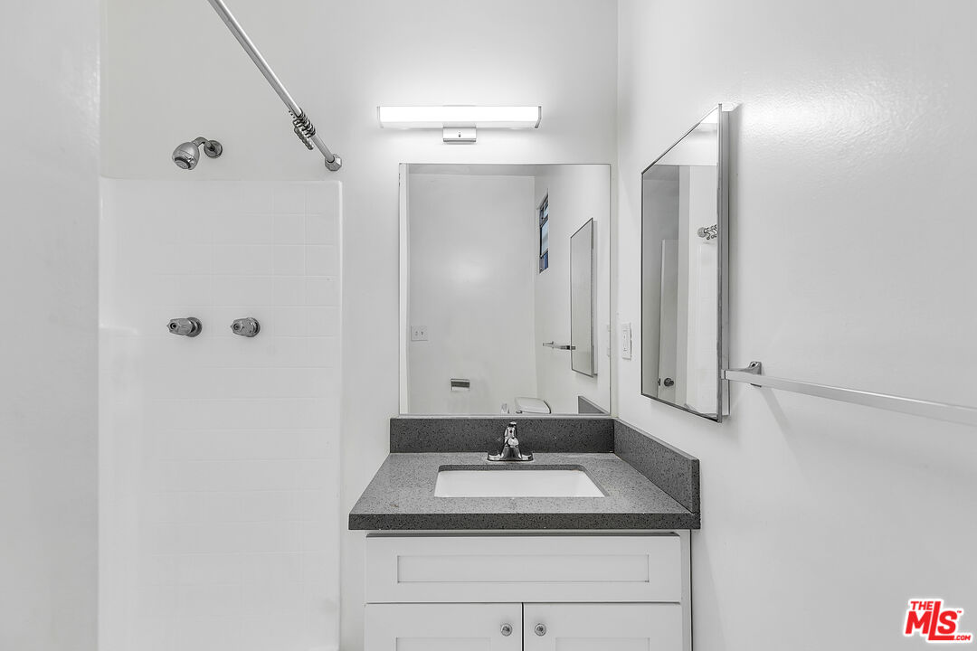 1812 North Gramercy Place, Unit 11 Los Angeles, CA 90028 - Photo 10 of 18 a bathroom with a sink and a mirror