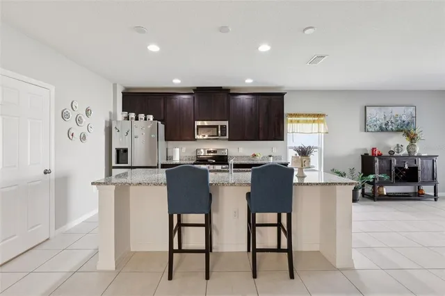 a kitchen with stainless steel appliances granite countertop a sink stove and microwave