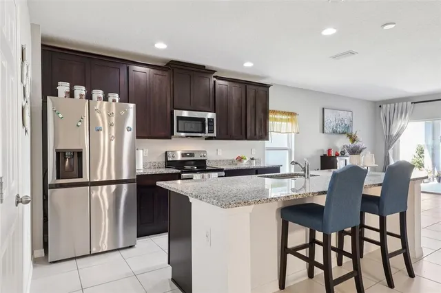a kitchen with a sink and a mirror