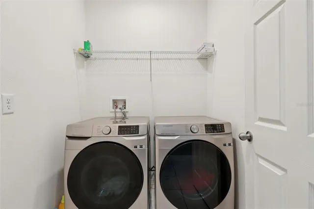 a bathroom with a double vanity sink toilet and a mirror