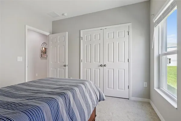 a bedroom with a bed and dresser